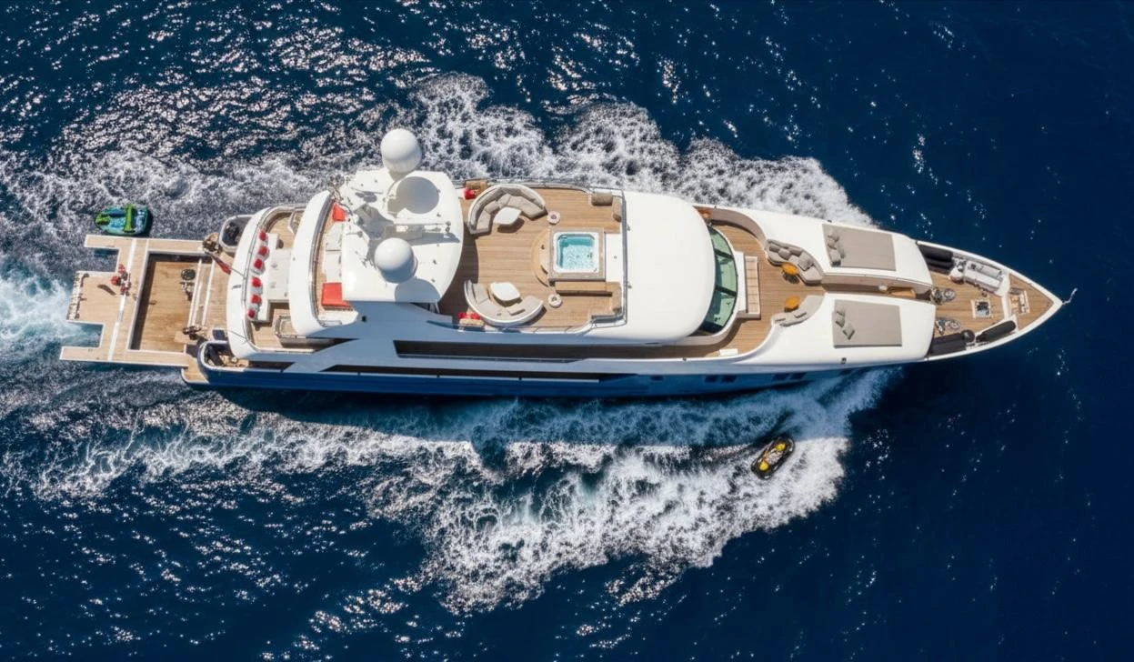 Private motor yacht cruising along a Mediterranean coastline