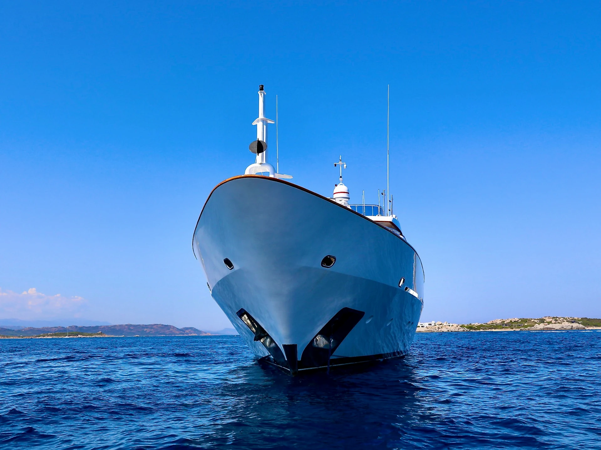 Yacht photographed front-on against clear Mediterranean water