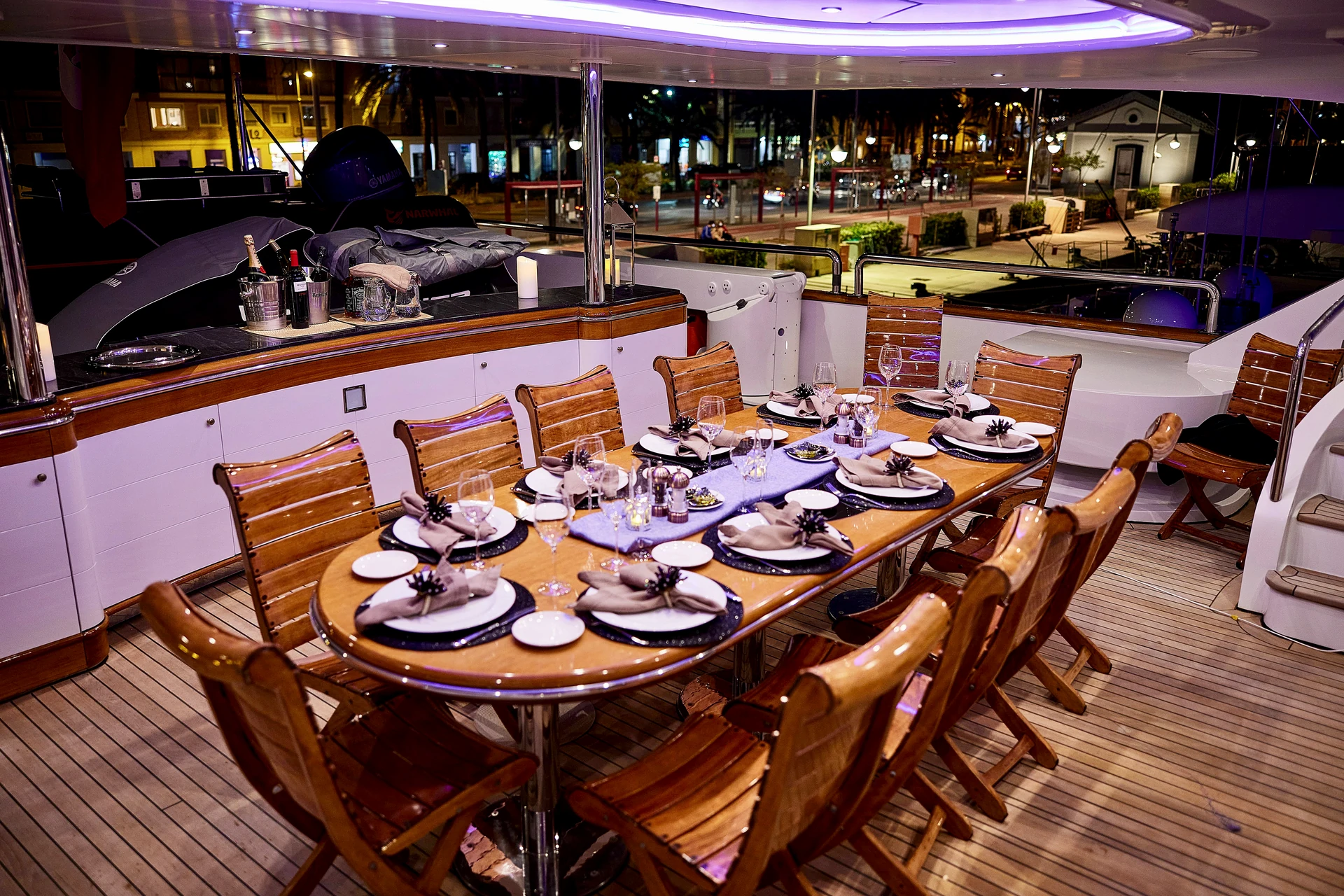 Long exterior yacht table prepared for an evening meal