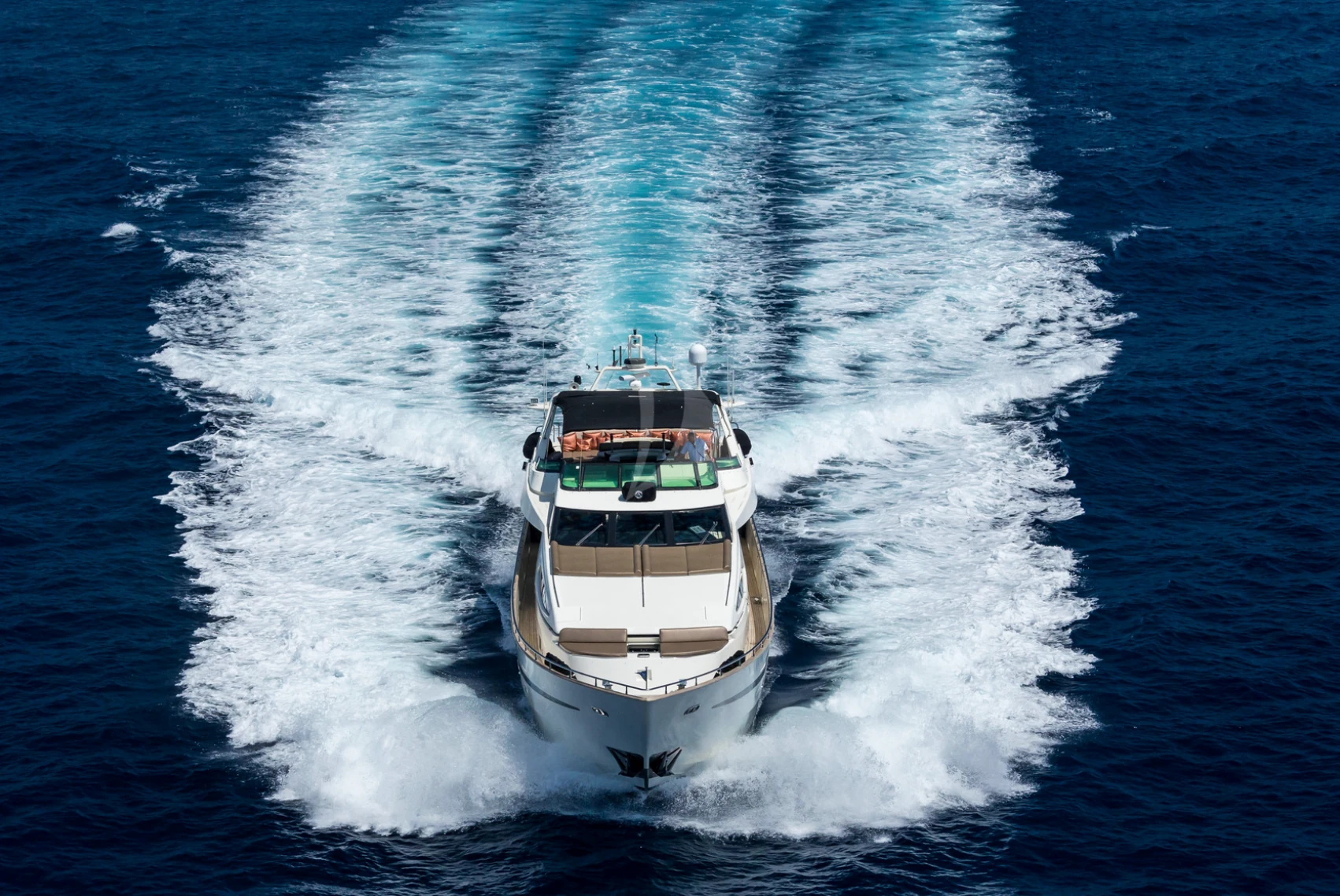 Motor yacht photographed from above while underway on open water