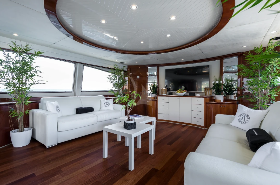 Bright yacht salon with pale seating, timber joinery and broad windows